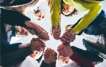 addiction recovery group holding hands