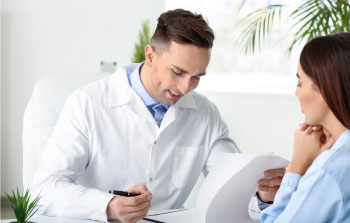 doctor speaking to client in detox clinic